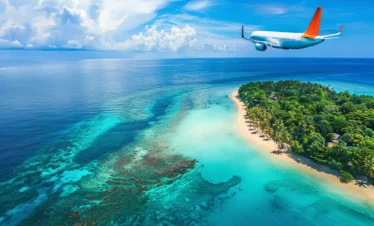 Classic Kerala Tour Package featuring a tropical island beach, turquoise waters, lush greenery, and a scenic flight over the Arabian Sea