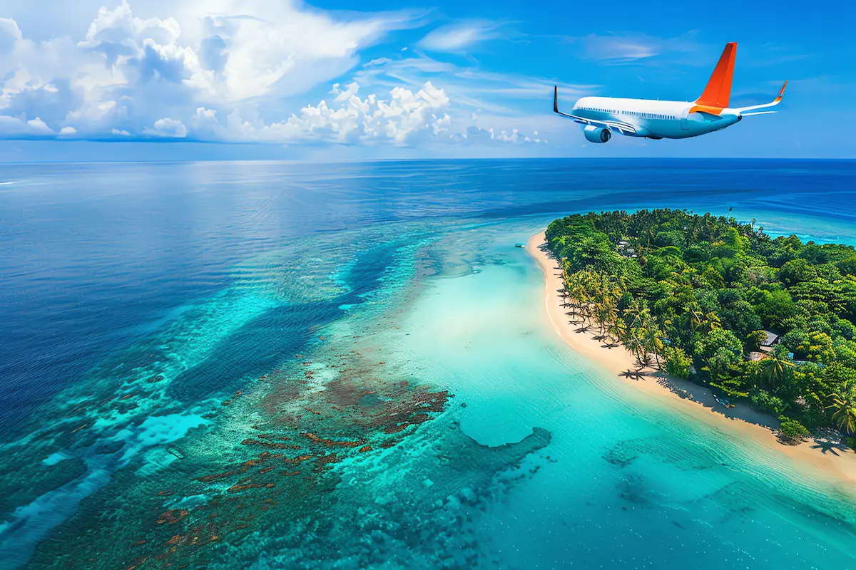 Classic Kerala Tour Package featuring a tropical island beach, turquoise waters, lush greenery, and a scenic flight over the Arabian Sea