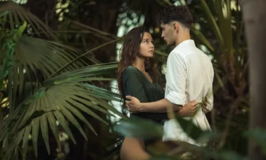 Romantic couple enjoying a Kerala honeymoon tour package surrounded by tropical greenery and serene nature